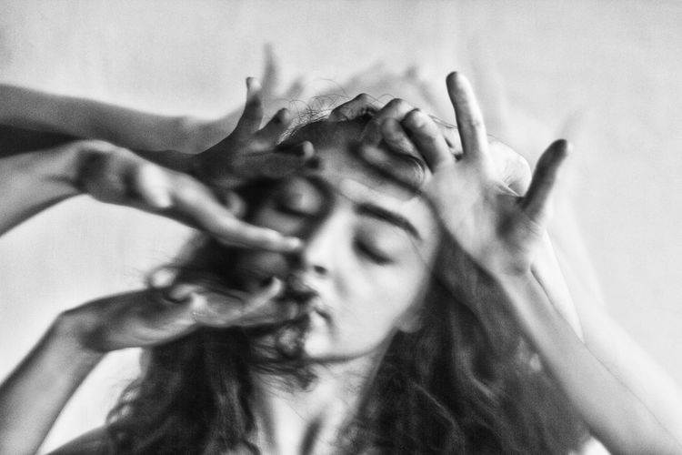 Blurred motion of hands hitting woman