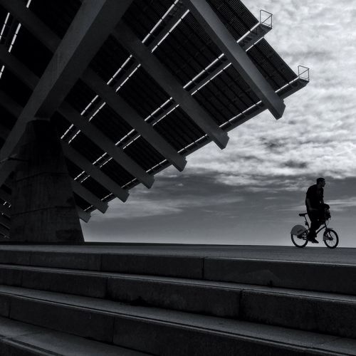 Low angle view of man riding bicycle on building