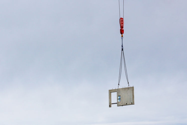 Concrete prefab element hoisted by a construction crane