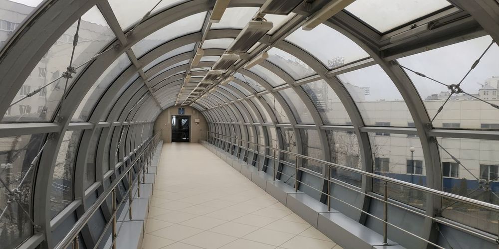 Glass tunnel transition between buildings in a city hospital