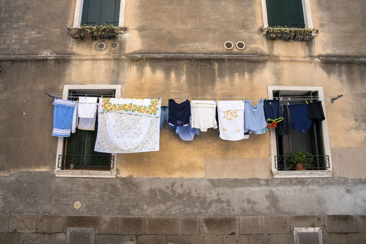 Clothes hanging to dry on clothesline of residential building