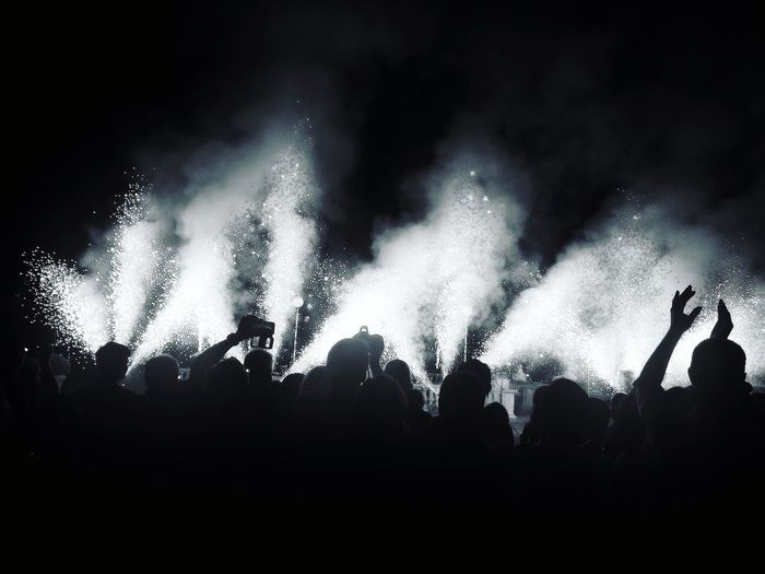 Low angle view of firework display at night