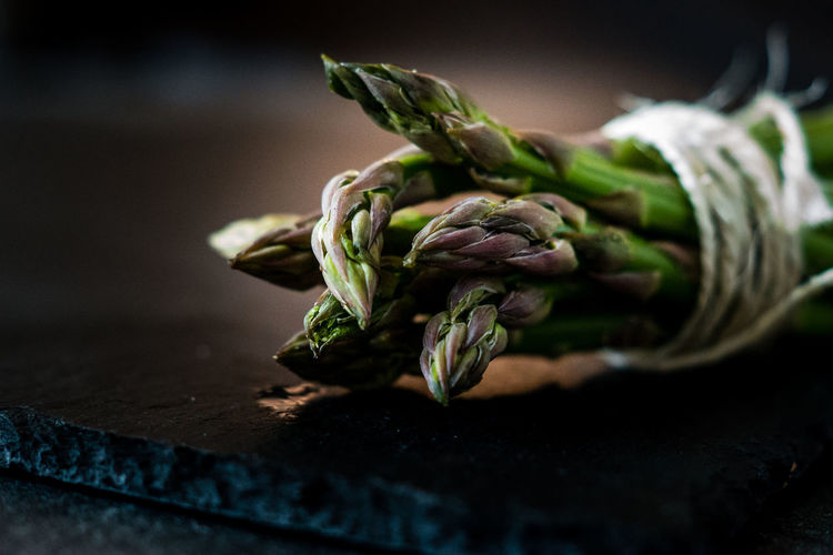 Close-up of green asparagus on table