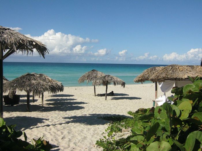 Scenic view of beach against cloudy sky