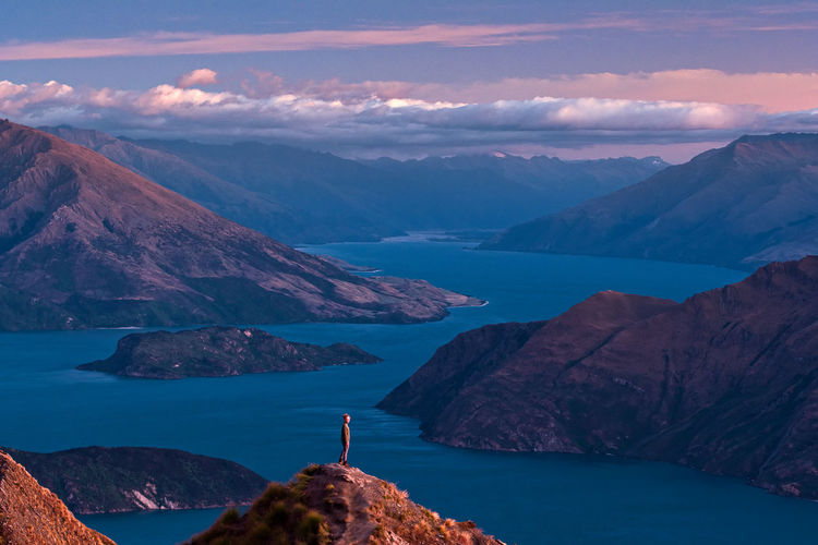 Scenic view of sea and mountains against sky