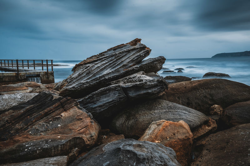 Rocks on shore at beach 