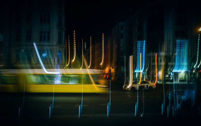 Light trails and vehicles on road at night