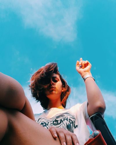 Low angle view of woman against sky