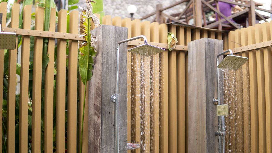 Water falling from the rain shower head of an outdoor swimming pool area.