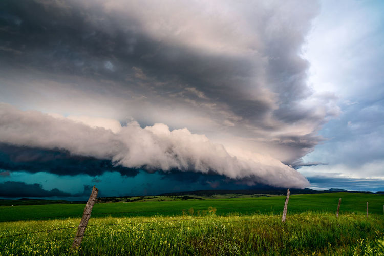 Scenic view of landscape against storm cloud