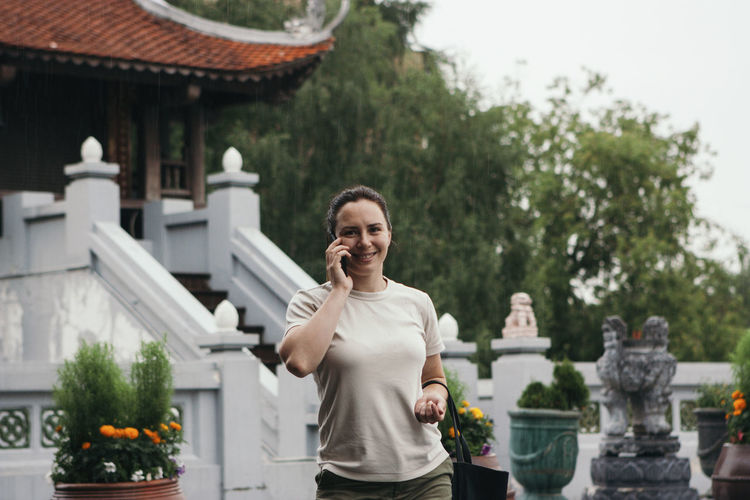 Young woman outdoors near oriental pagoda