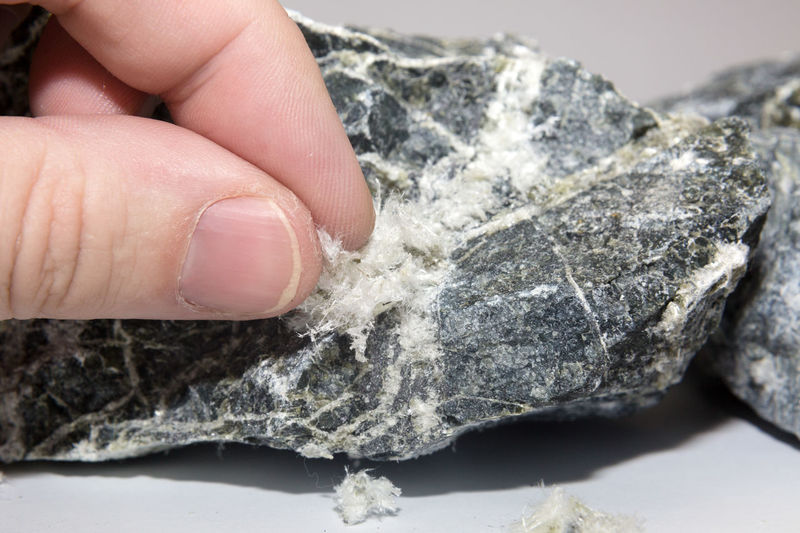Asbestos mineral fiber human fingers, close-up. macro photography.