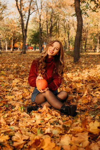 Portrait of smiling young woman in autumn