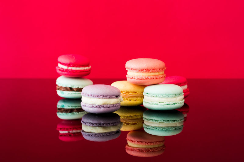 Close-up of multi colored candies against red background