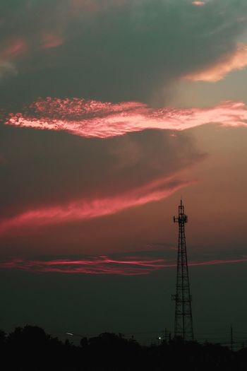 Low angle view of silhouette tower against dramatic sky during sunset