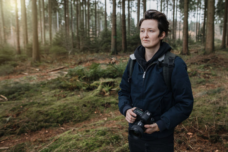 Young man standing in forest