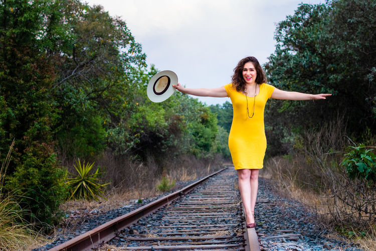 Full length of woman standing on railroad track