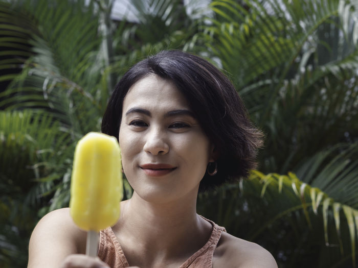 Smiling woman holding ice cream