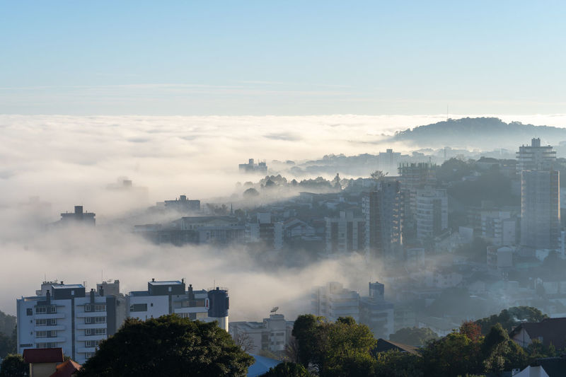 High angle view of buildings in city against sky
