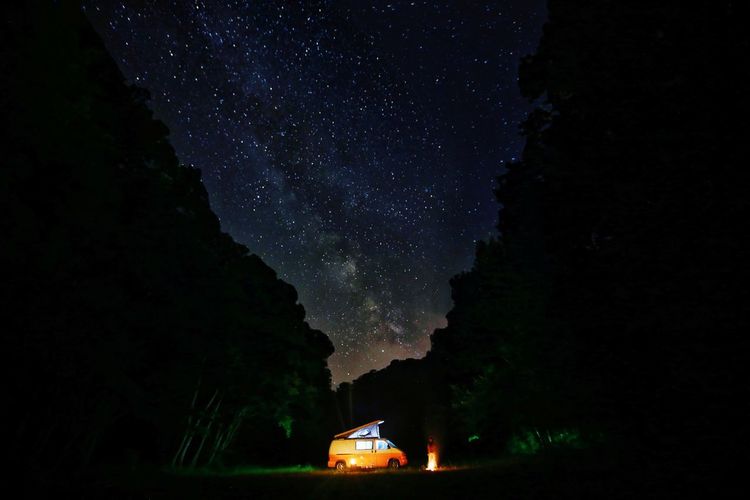 Bonfire by caravan in forest