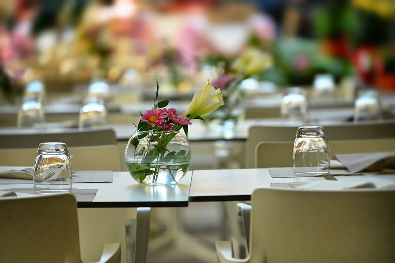 Flower vase on table at restaurant