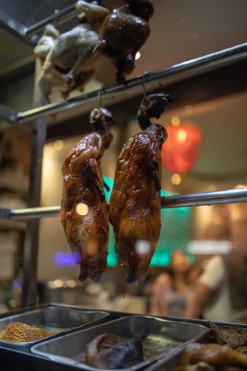 Close-up of meat hanging in kitchen at restaurant