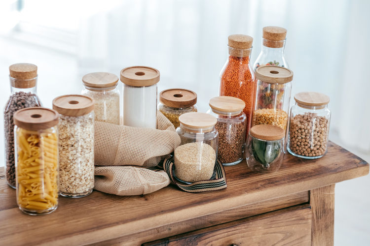Zero waste concept. textile eco-bags glass jars on wooden table in the kitchen.