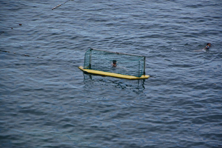 High angle view of people playing in sea