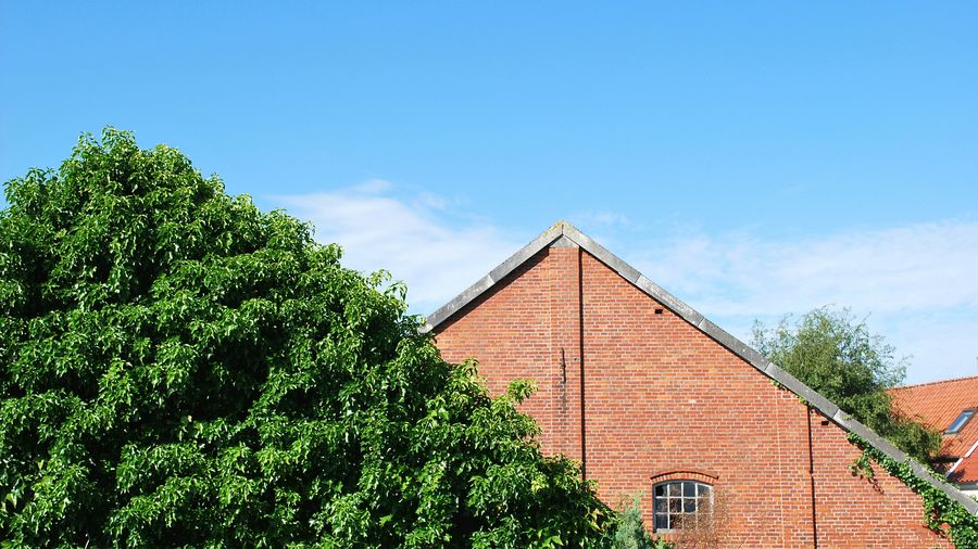 Low angle view of houses against blue sky