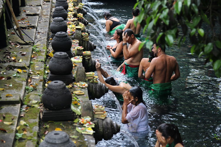 People waiting for bath in fountain at temple