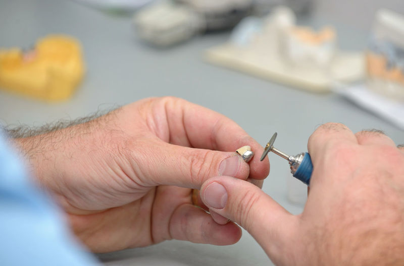 Cropped hands of male dental technician working in laboratory