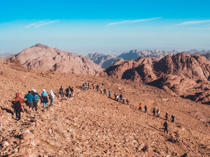 View of people in desert against blue sky