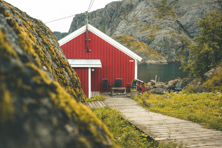 View of house by building against sky in lofoten