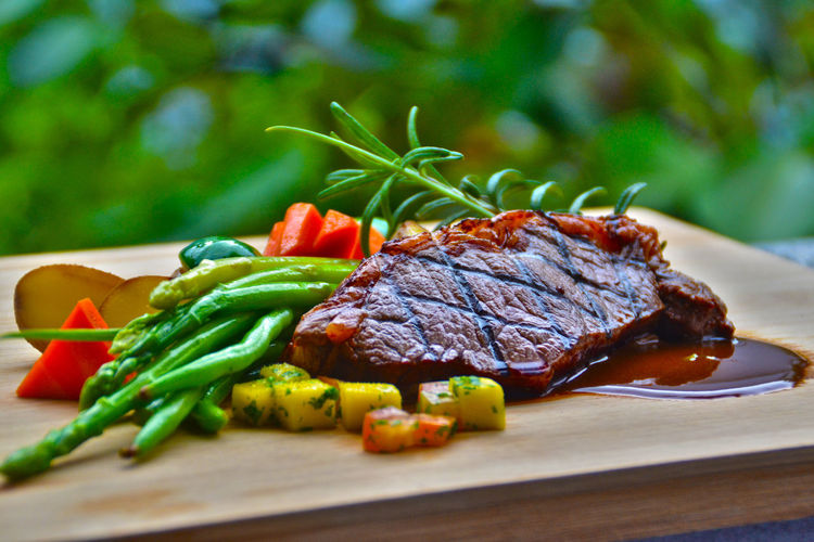 Close-up of steak with vegetables on cutting board