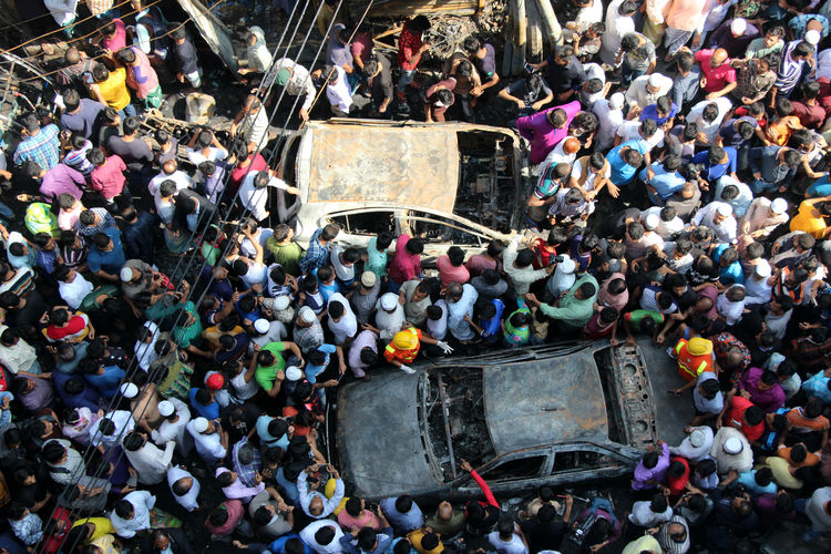 High angle view of crowd standing by car accident on road