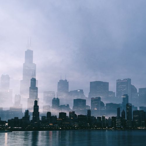Multiple image of cityscape emerging over water