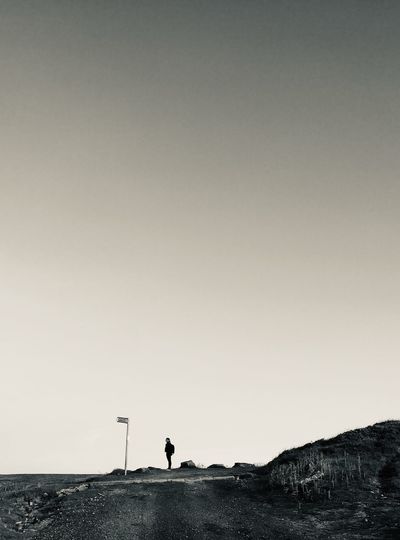 Mid distance of woman standing on land against sky