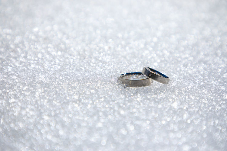 Surface level of wedding rings on snow