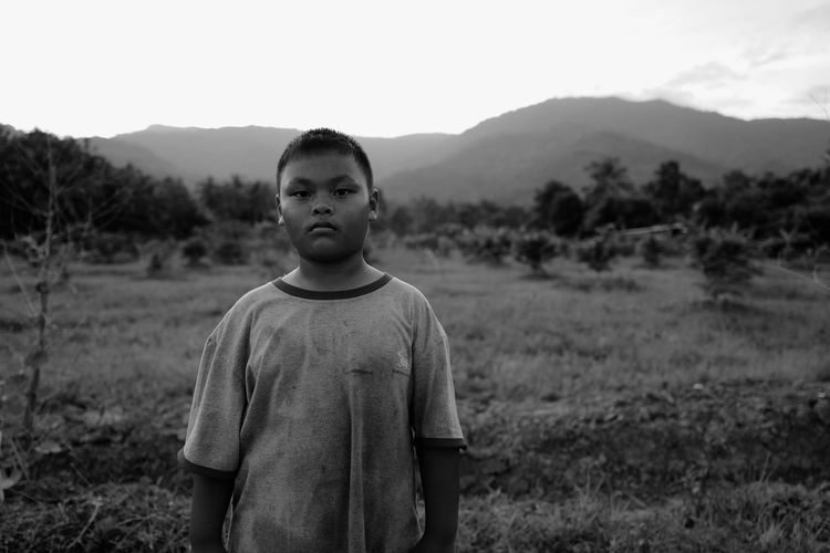 Portrait of boy standing on field