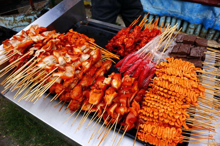 Photo of assorted grilled pork and chicken innards barbecue at a street food stall