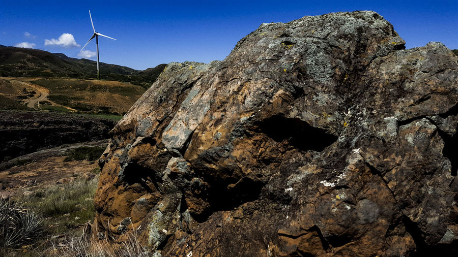 Low angle view of rock formation on land against sky
