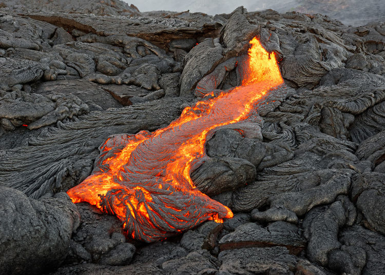 Hot magma of an active lava flow emerges from a fissure, hawaii, big island, kilauea, kalapana