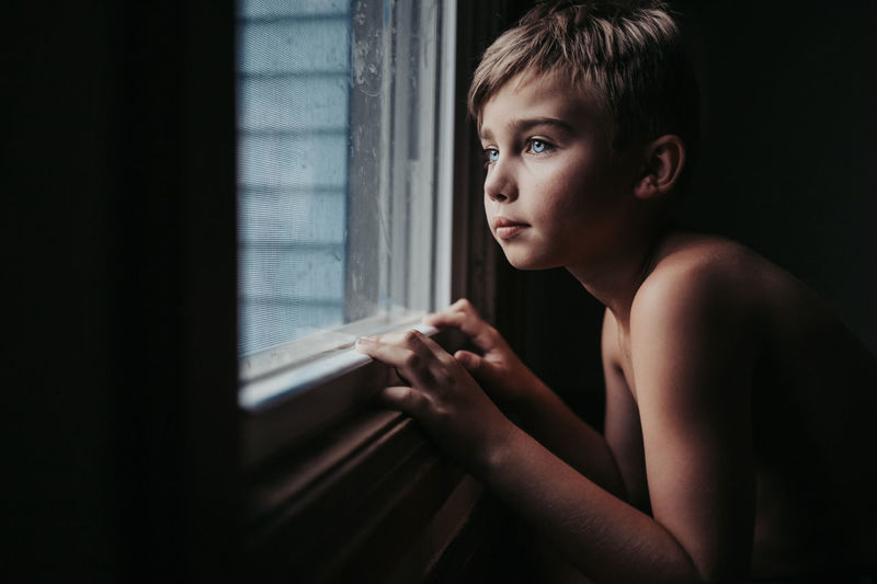 Portrait of boy looking away at home