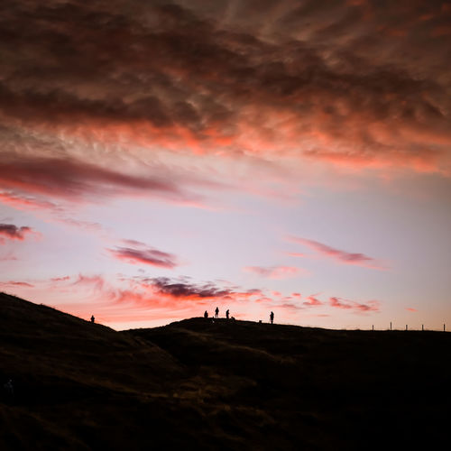 Scenic view of landscape against cloudy sky