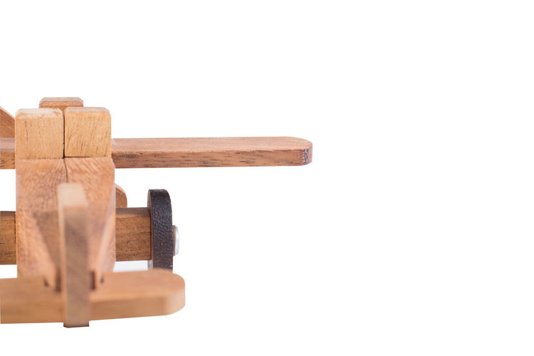 Close-up of wooden post against white background