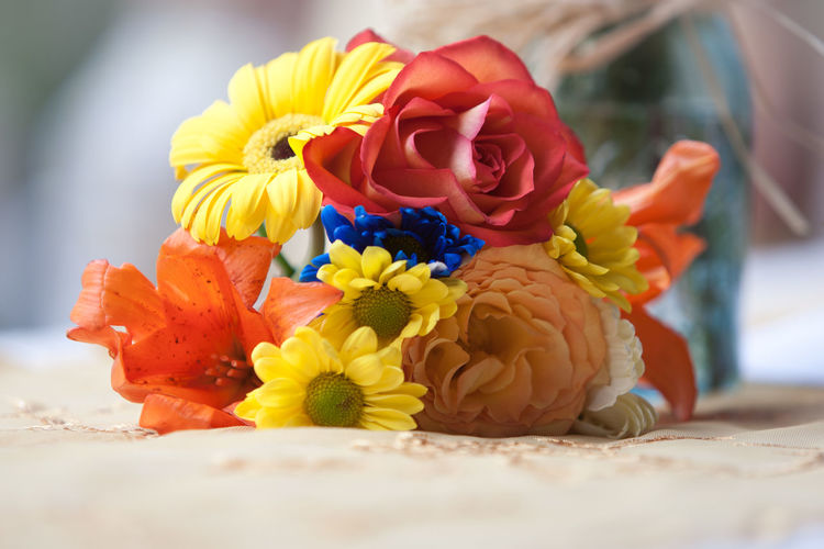 Bouquet of colorful flowers on tablecloth