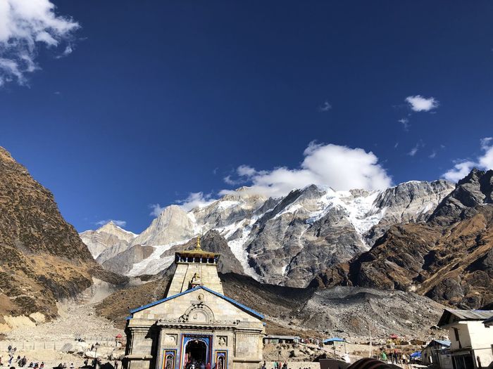 Scenic view of snowcapped mountains against blue sky and kedarnath dhan