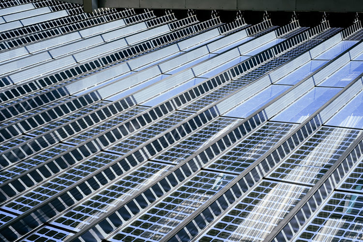 Detail view on metal and glass roof construction with solar panels