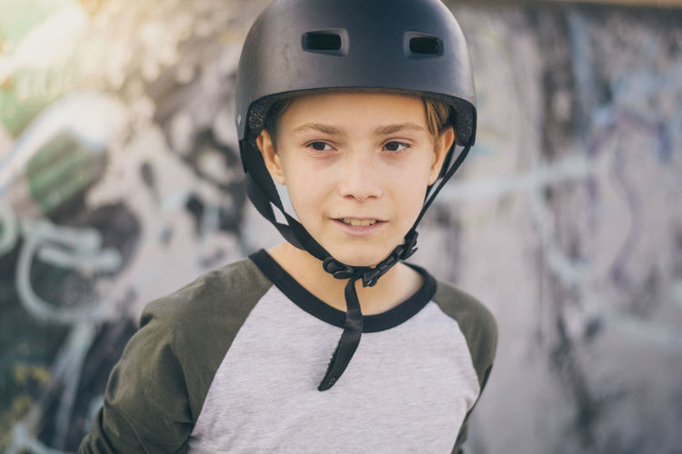 Boy wearing crash helmet outdoors