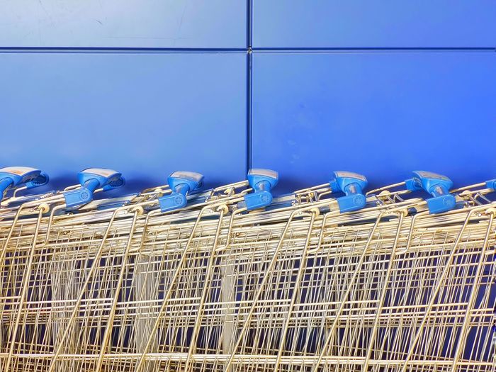 Close-up of metal grate against blue wall